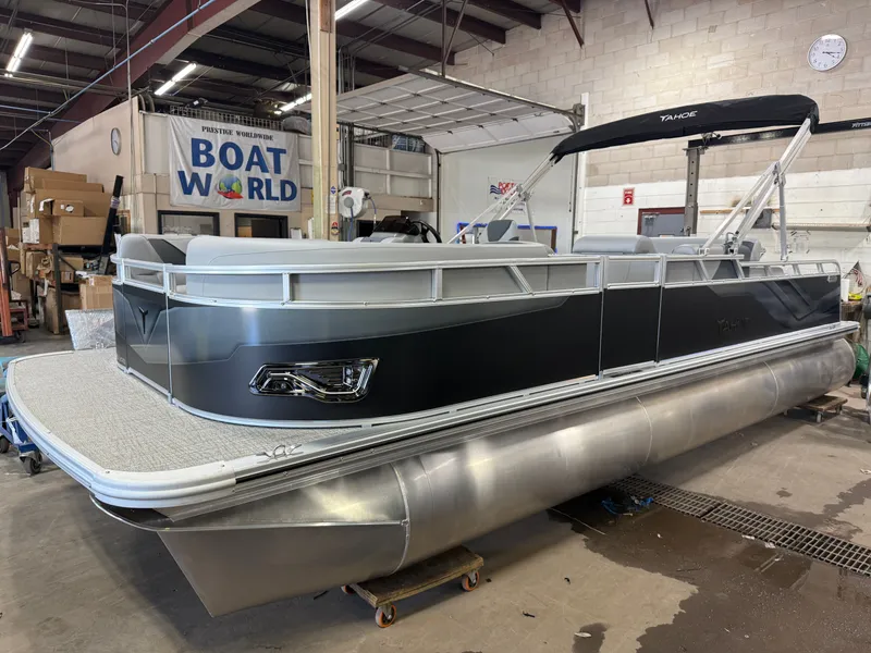 Slide: The Image of 2025 Tahoe Sport 2385 Swingback pontoon boat in showroom, featuring Honda 4-Stroke EFI engine. - 35