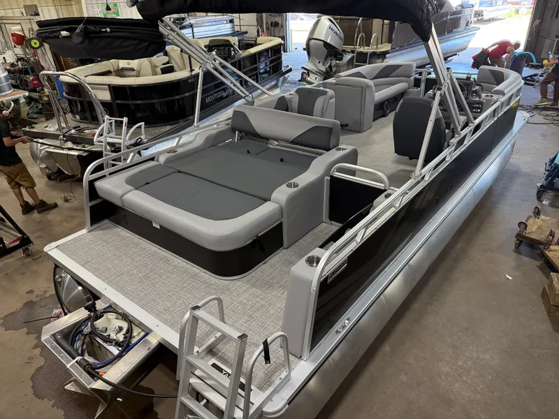 Slide: The Image of 2025 Tahoe Sport 2385 Swingback pontoon boat with Honda 4-Stroke EFI engine in a workshop. - 42