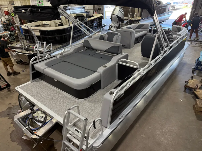 Slide: The Image of 2025 Tahoe Sport 2385 Swingback pontoon boat with Honda 4-Stroke EFI engine in a workshop. - 43