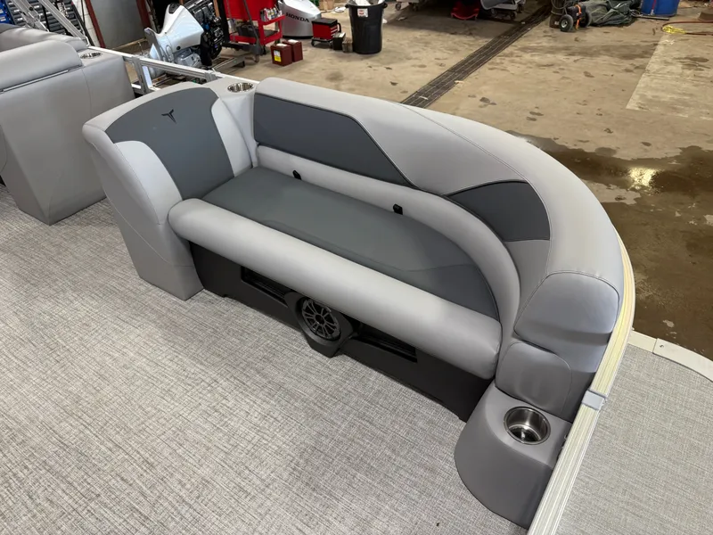 Slide: The Image of 2025 Tahoe Sport 2385 Swingback VRB boat interior with gray seating and cup holder. - 8