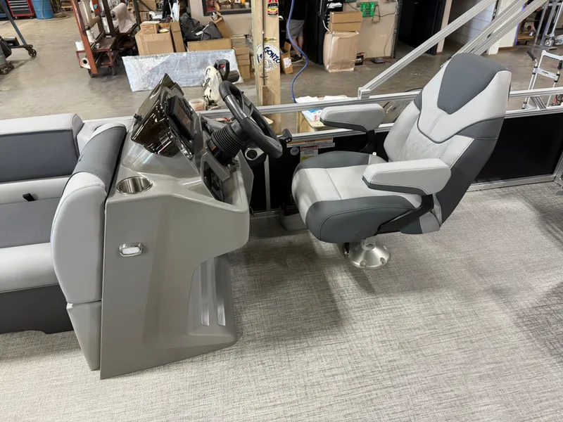 Slide: The Image of 2025 Tahoe Sport 2385 Swingback VRB boat interior with steering console and captain's chair. - 9
