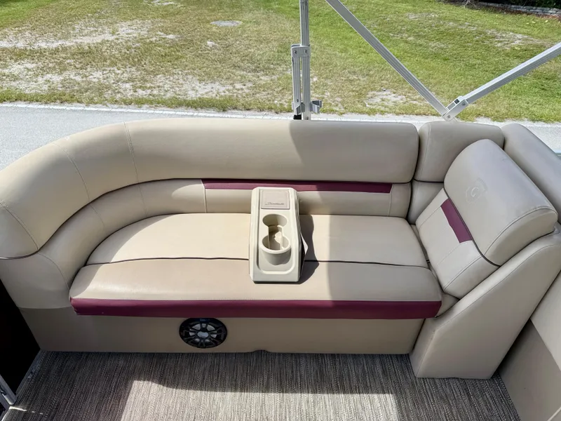 Slide: The Image of 2022 Godfrey Sweetwater 2286 C boat seating with cup holders, beige and maroon upholstery. - 10