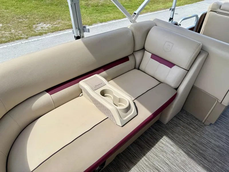 Slide: The Image of 2022 Godfrey Sweetwater 2286 C boat interior with beige seating and cup holders. - 11