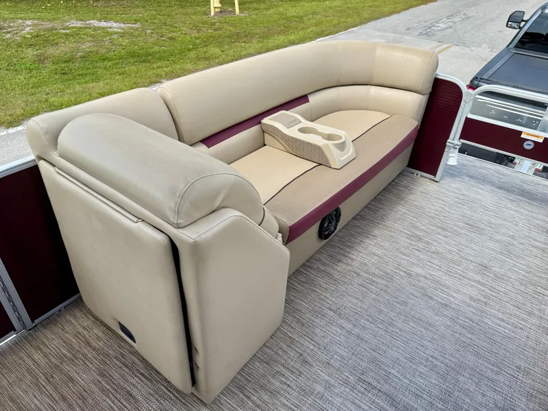 Slide: The Image of 2022 Godfrey Sweetwater 2286 C pontoon boat with beige seating and cup holders. - 14