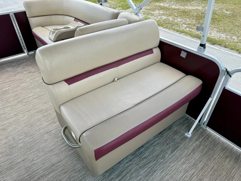 Slide: The Image of 2022 Godfrey Sweetwater 2286 C boat interior with beige and maroon seating. - 19