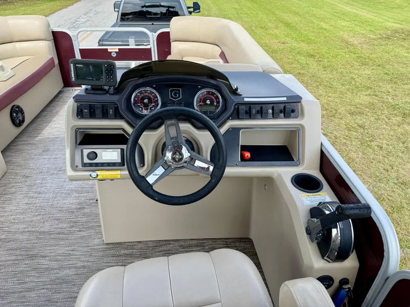 Slide: The Image of 2022 Godfrey Sweetwater 2286 C boat dashboard with steering wheel and control panel. - 21