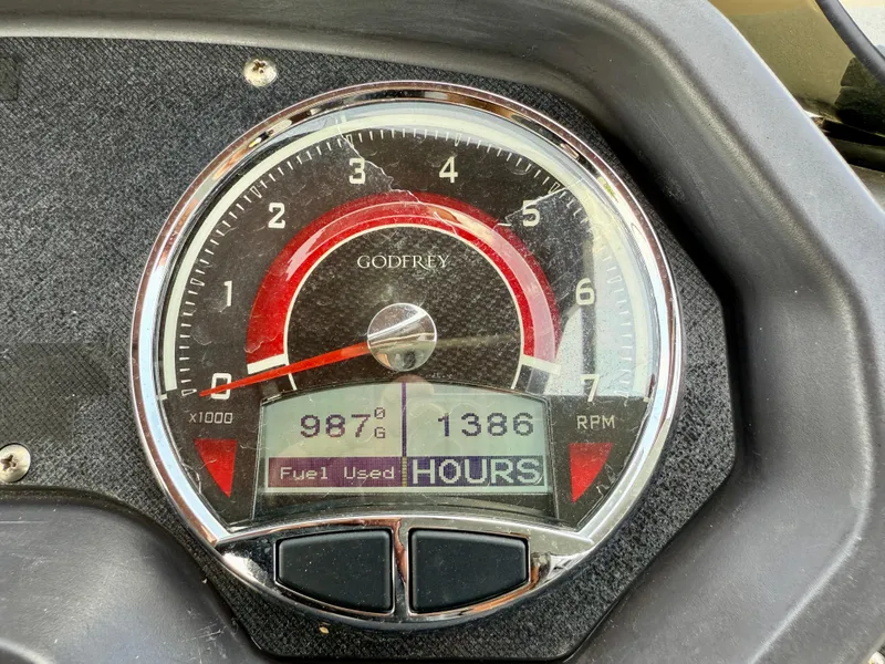 Slide: The Image of Close-up of 2022 Godfrey Sweetwater 2286 C tachometer showing RPM and fuel usage. - 23