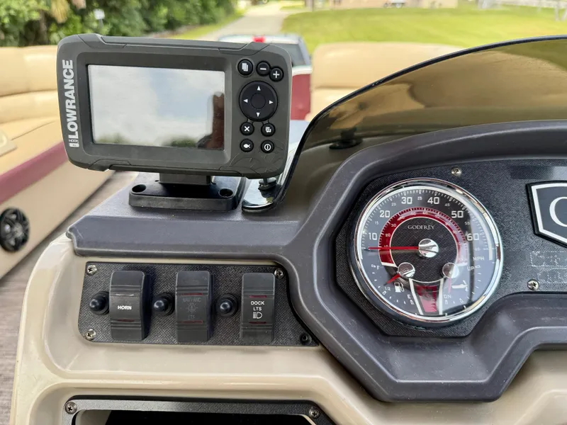 Slide: The Image of Dashboard of 2022 Godfrey Sweetwater 2286 C with Lowrance device and speedometer. - 24