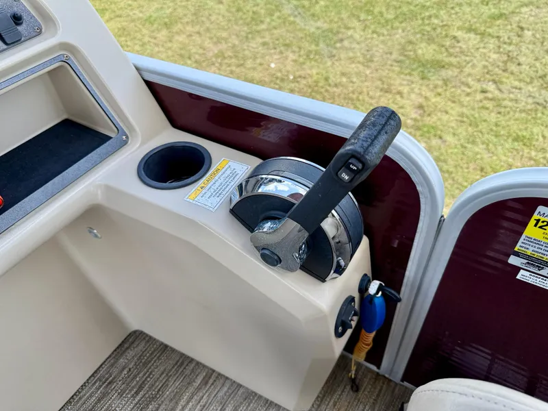 Slide: The Image of Control panel of 2022 Godfrey Sweetwater 2286 C boat with throttle lever and cup holder. - 28