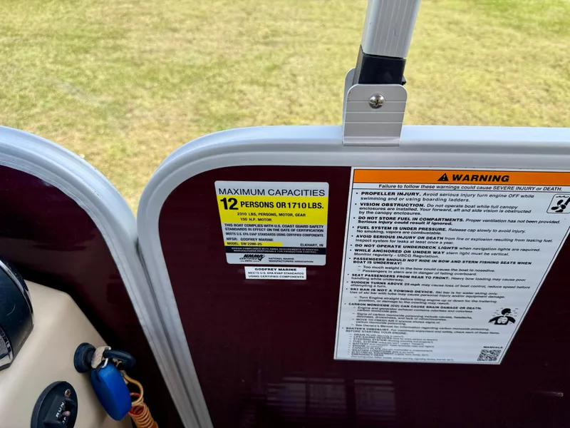 Slide: The Image of 2022 Godfrey Sweetwater 2286 C boat capacity warning labels, maximum 12 persons or 1710 lbs. - 29