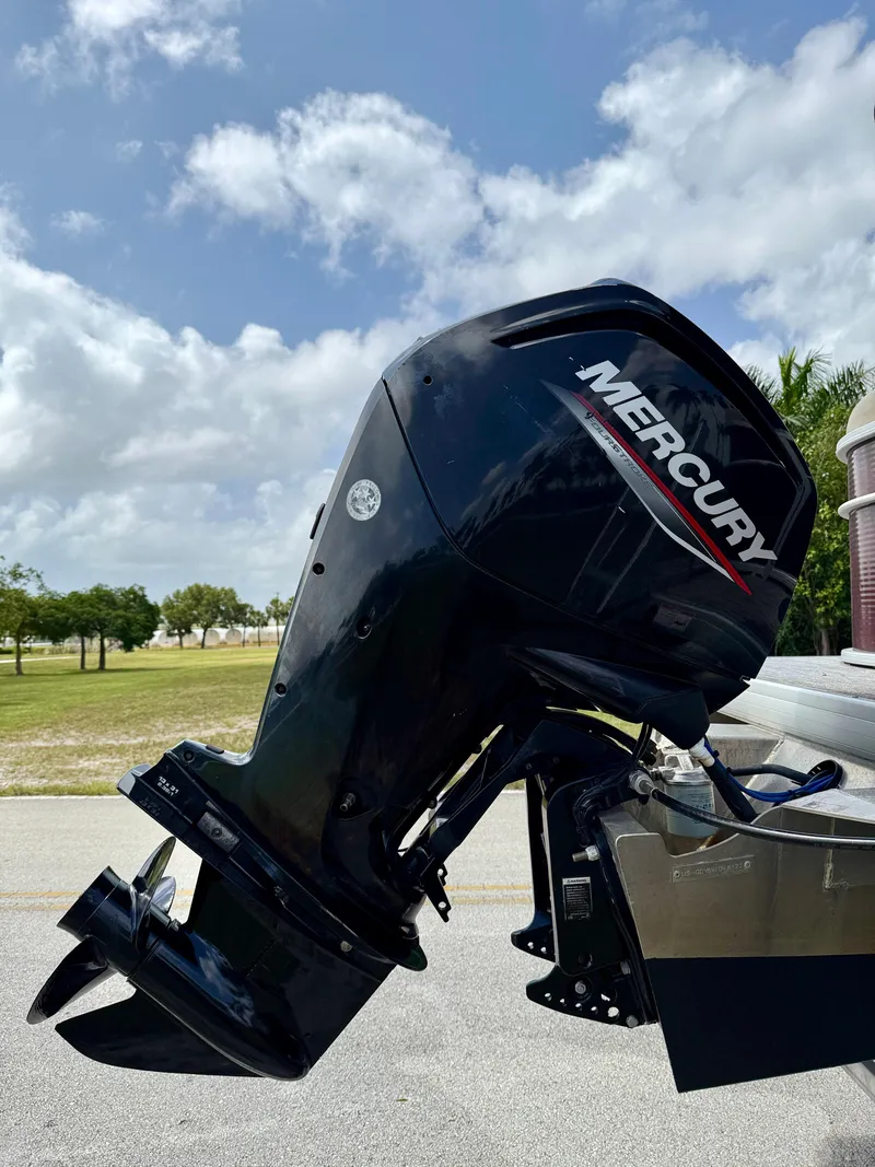 Slide: The Image of Outboard motor on a 2022 Godfrey Sweetwater 2286 C boat, parked outdoors. - 31
