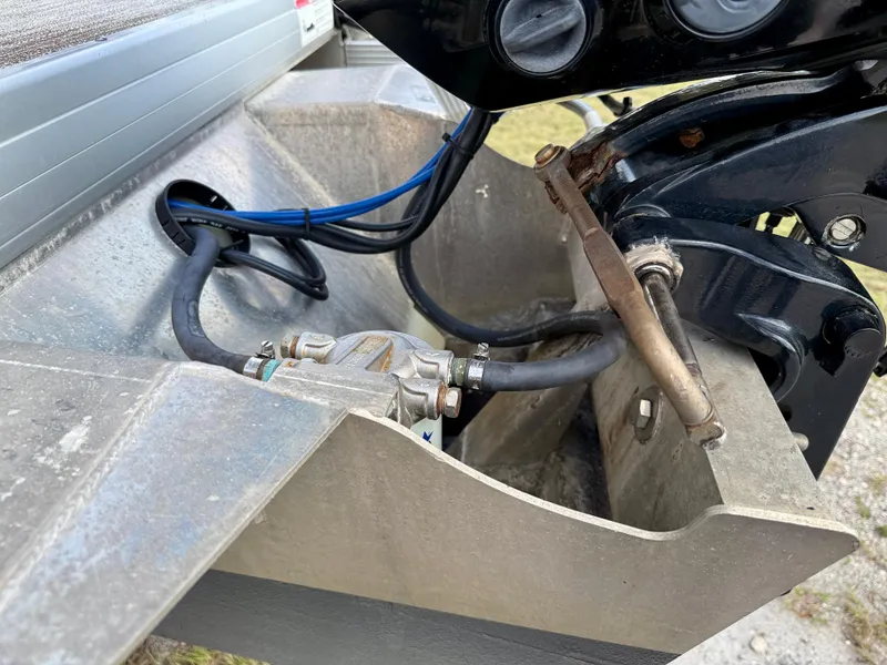 Slide: The Image of 2022 Godfrey Sweetwater 2286 C boat engine compartment with hoses and metal components. - 32