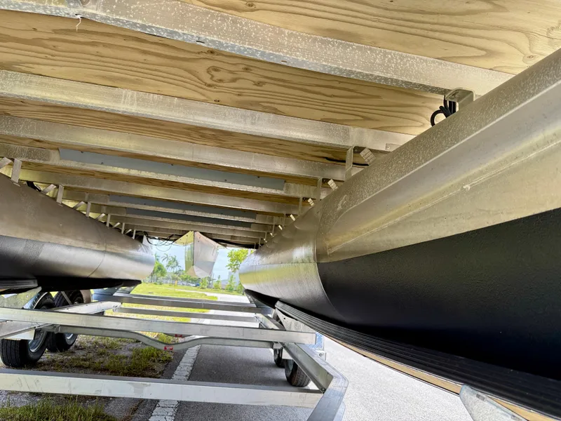 Slide: The Image of Underneath view of a 2022 Godfrey Sweetwater 2286 C pontoon boat on a trailer. - 35