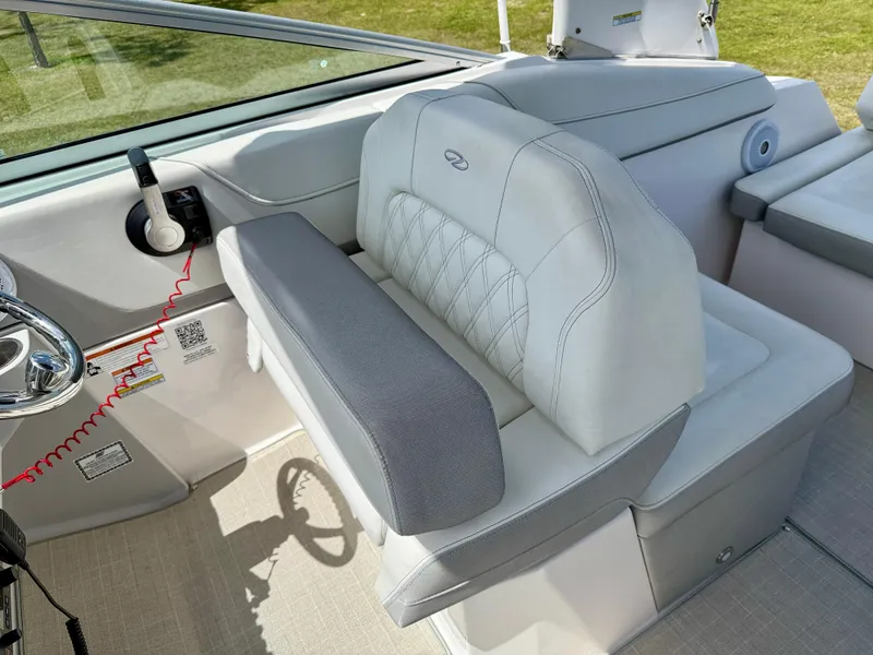 Slide: The Image of 2021 Regal 26 XO boat interior with plush seating and steering wheel. - 10