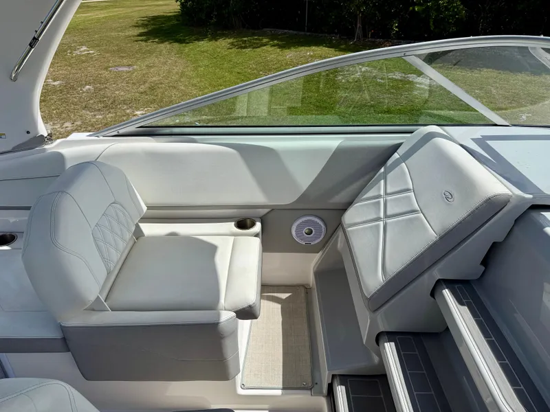 Slide: The Image of 2021 Regal 26 XO boat interior with gray seating and cup holders. - 13