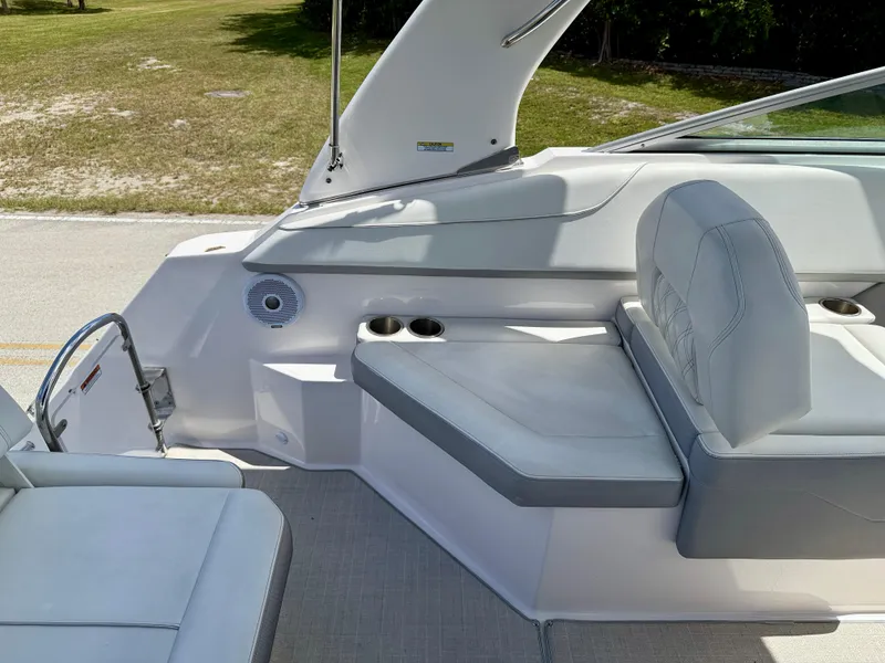 Slide: The Image of 2021 Regal 26 XO boat interior with white seating and cup holders. - 17