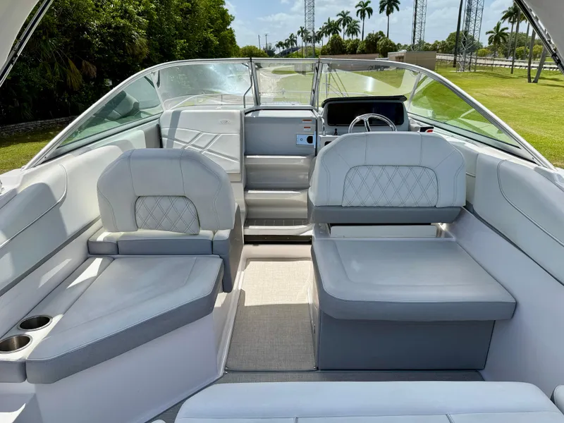 Slide: The Image of 2021 Regal 26 XO boat interior with luxurious seating and modern dashboard. - 18