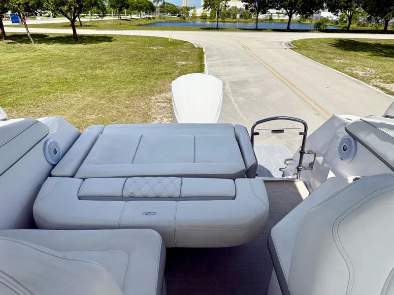 Slide: The Image of 2021 Regal 26 XO boat interior with plush seating and scenic outdoor view. - 20