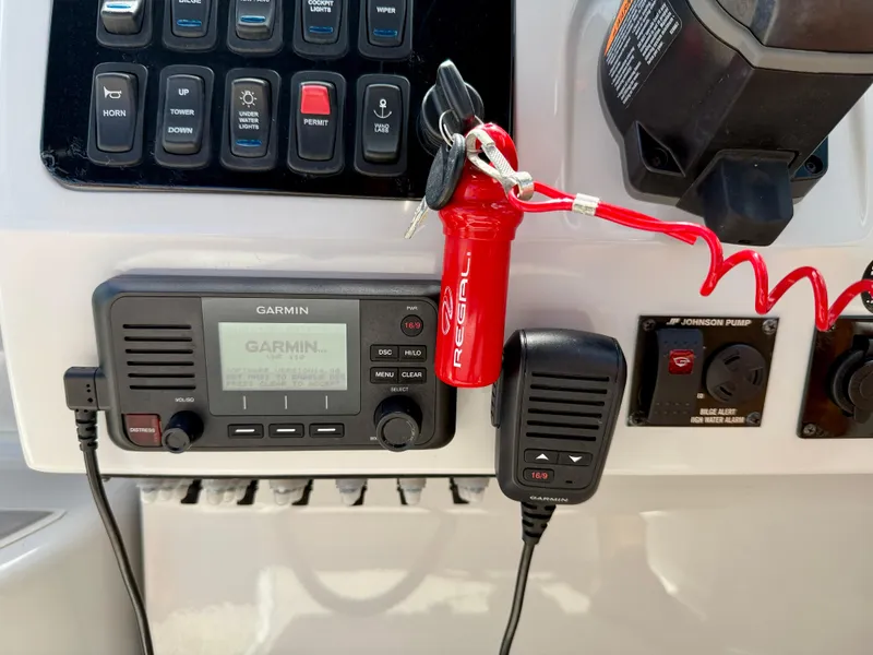 Slide: The Image of Control panel of 2021 Regal 26 XO boat with Garmin radio and safety features. - 25