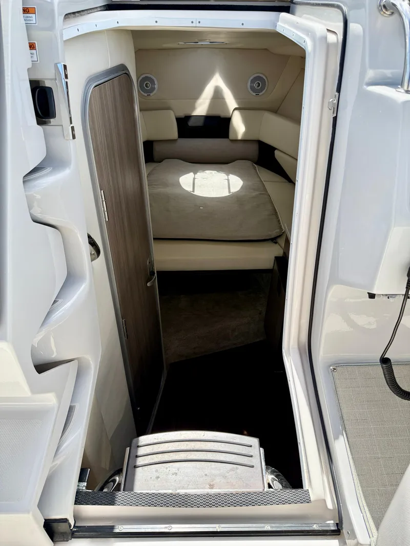 Slide: The Image of Interior cabin of a 2021 Regal 26 XO boat, featuring a cozy seating area. - 28