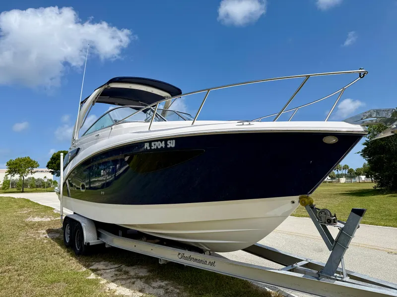 Slide: The Image of 2021 Regal 26 XO boat on trailer under clear blue sky. - 3