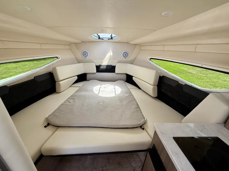 Slide: The Image of Interior of 2021 Regal 26 XO boat with beige seating and windows. - 30