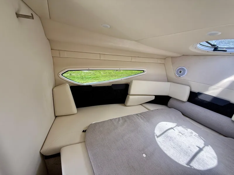 Slide: The Image of Interior cabin of 2021 Regal 26 XO boat with beige seating and window. - 31