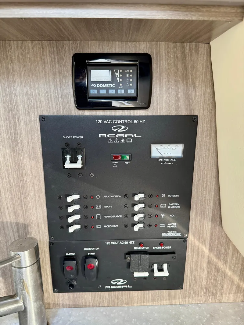 Slide: The Image of Control panel of a 2021 Regal 26 XO boat, featuring various switches and a Dometic display. - 35