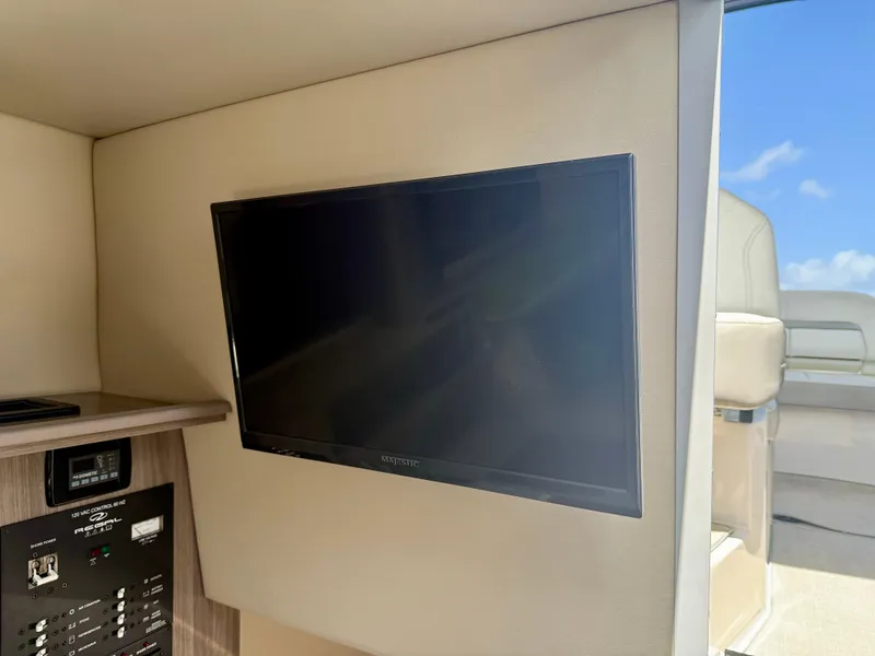 Slide: The Image of 2021 Regal 26 XO interior with wall-mounted TV and control panel. - 36