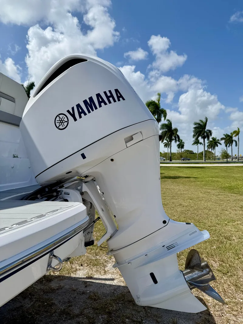 Slide: The Image of Yamaha outboard motor on a 2021 Regal 26 XO boat, with palm trees in the background. - 40
