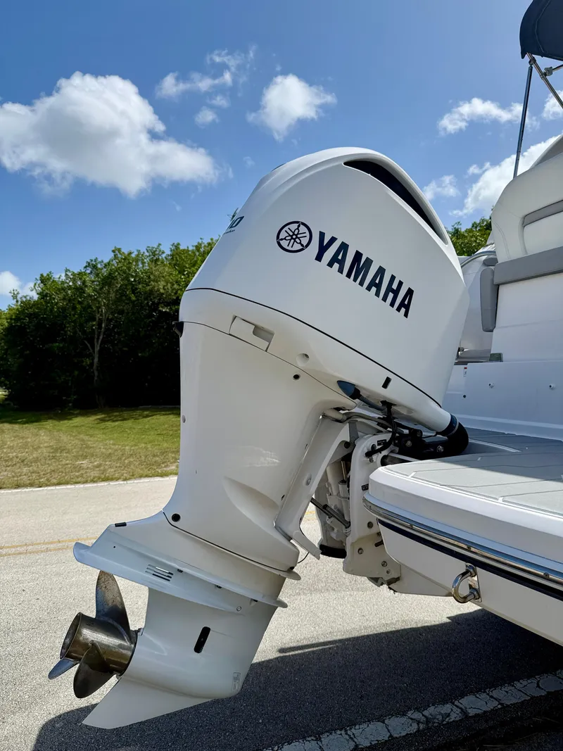 Slide: The Image of Yamaha outboard motor on 2021 Regal 26 XO boat, sunny day, blue sky. - 41