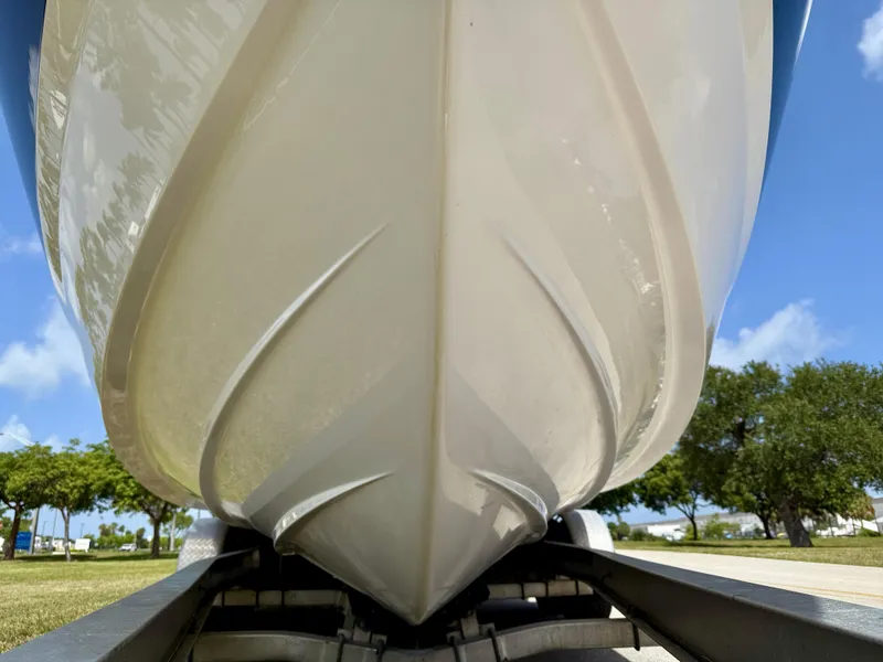 Slide: The Image of 2021 Regal 26 XO boat hull on trailer, viewed from below, with clear blue sky. - 43
