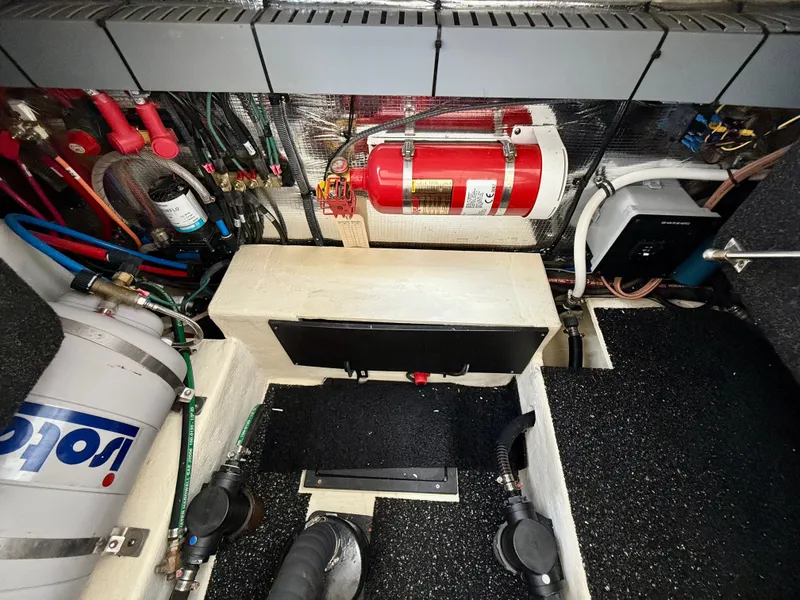 Slide: The Image of Engine compartment of a 2021 Regal 26 XO boat, featuring wiring and fire extinguisher system. - 45