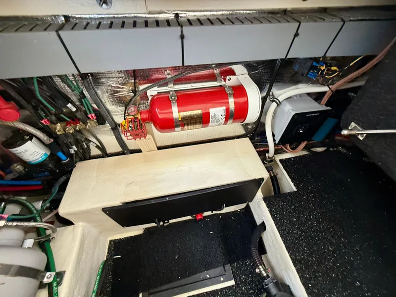 Slide: The Image of Engine compartment of a 2021 Regal 26 XO boat with fire extinguisher and wiring. - 47