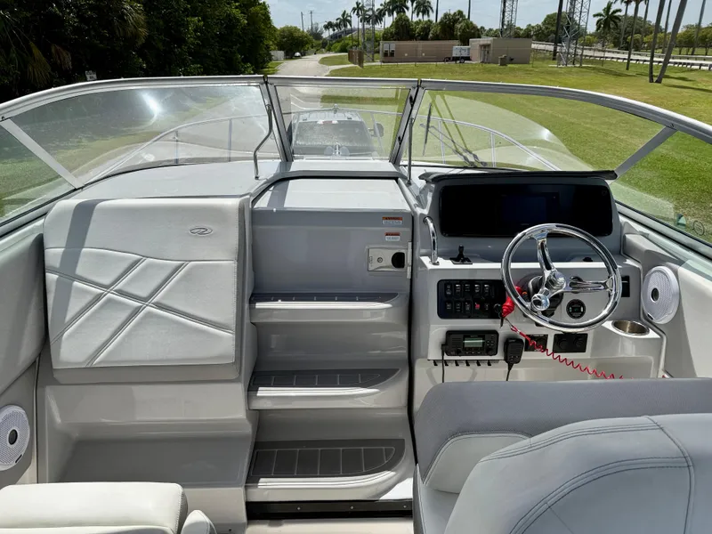 Slide: The Image of 2021 Regal 26 XO boat cockpit with modern steering and control panel. - 7