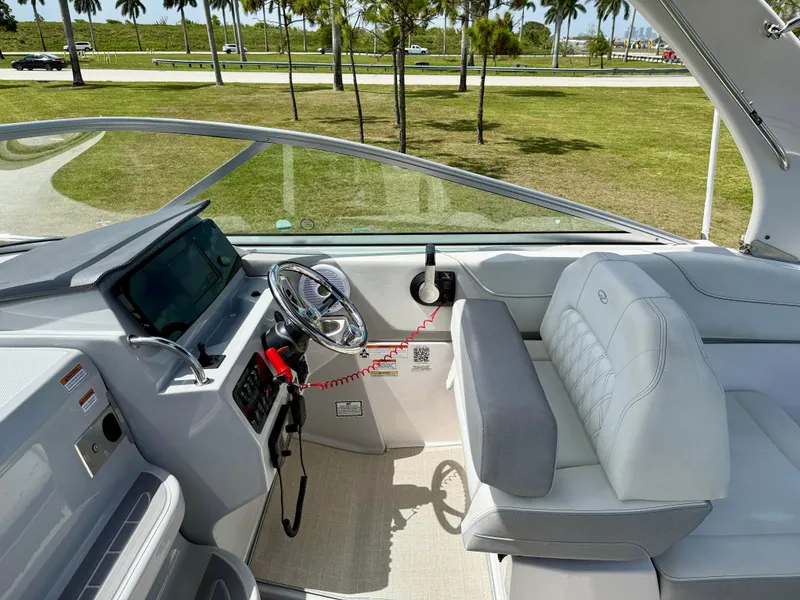 Slide: The Image of 2021 Regal 26 XO boat interior with steering wheel and seating, featuring modern design elements. - 9
