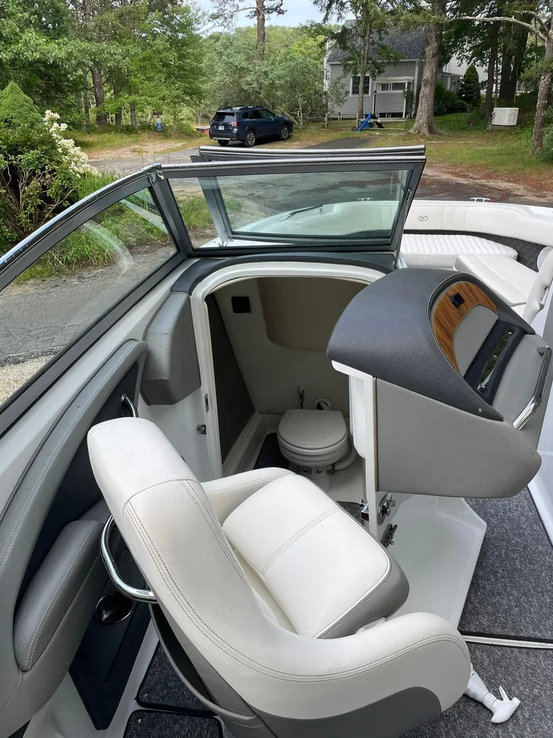 Slide: The Image of 2010 Cobalt 262 boat interior with seating and small cabin area. - 10