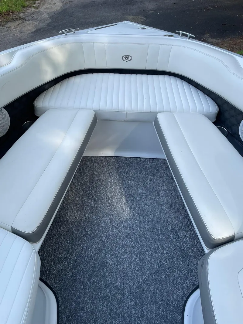 Slide: The Image of 2010 Cobalt 262 boat interior with white cushioned seating and gray carpet. - 11