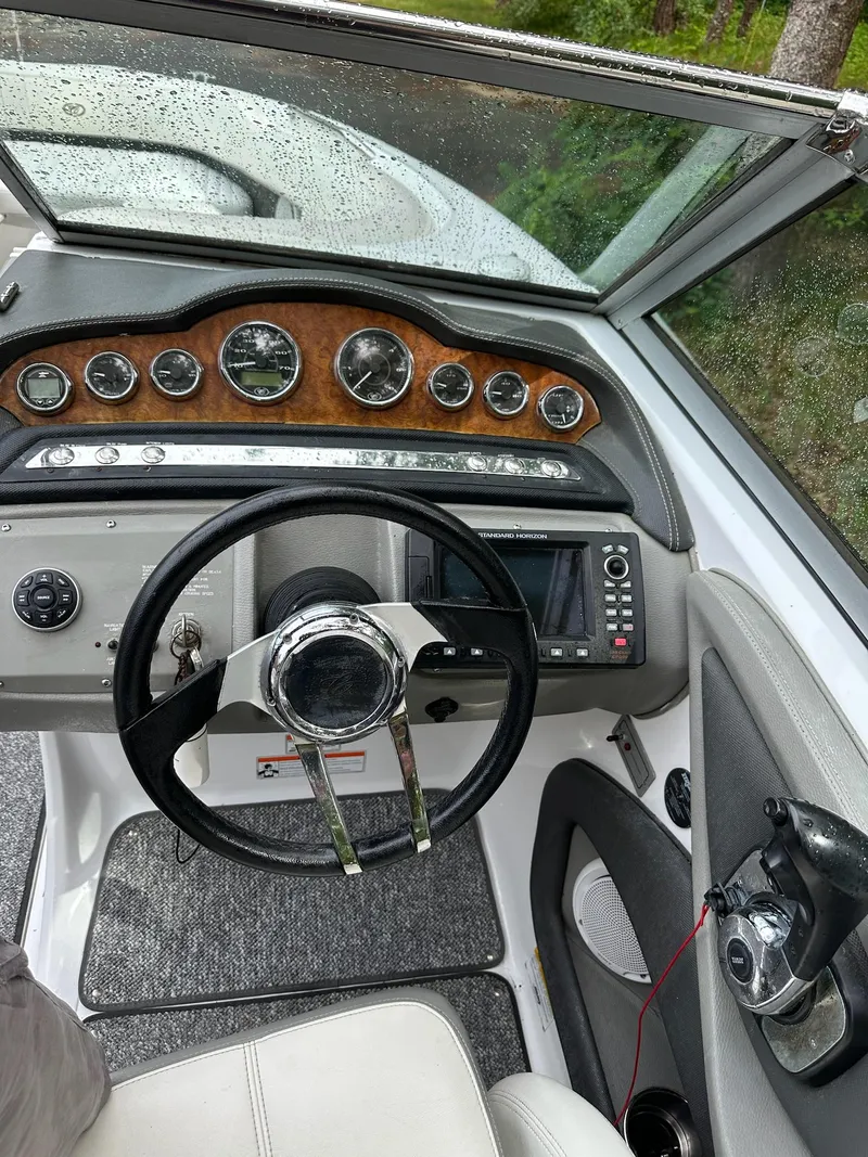 Slide: The Image of Steering console of a 2010 Cobalt 262 boat with gauges and navigation equipment. - 13