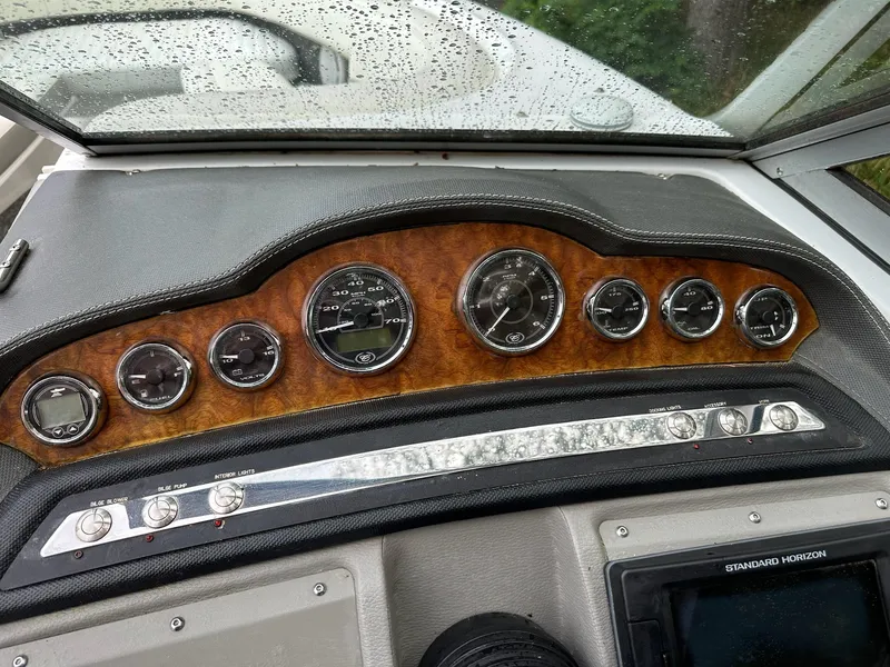 Slide: The Image of Dashboard of a 2010 Cobalt 262 boat with gauges and controls. - 14