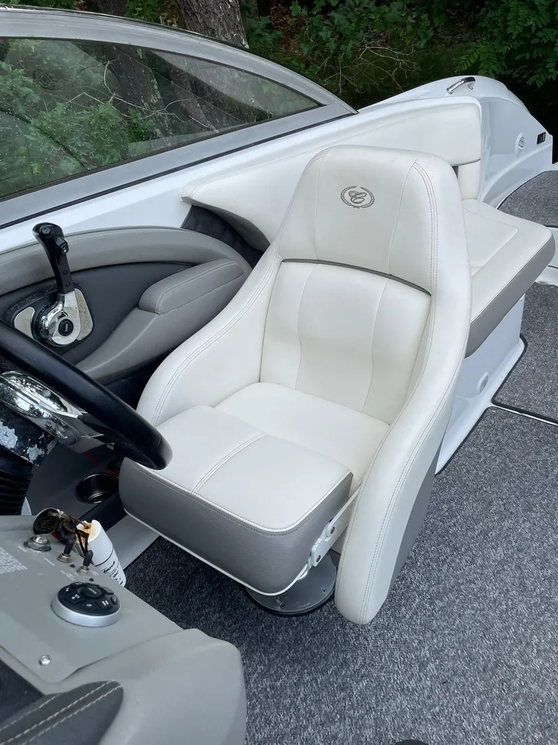 Slide: The Image of 2010 Cobalt 262 boat interior with white captain's seat and steering wheel. - 16