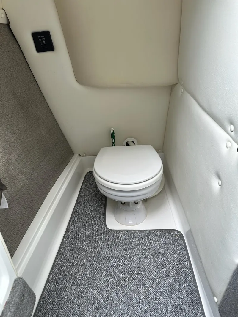 Slide: The Image of Compact marine toilet in a 2010 Cobalt 262 boat interior. - 17