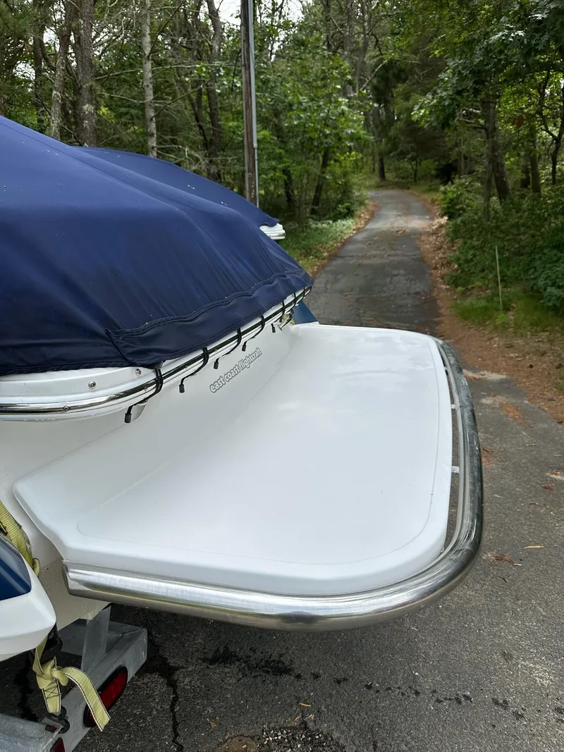 Slide: The Image of 2010 Cobalt 262 boat with blue cover on a forested path. - 5
