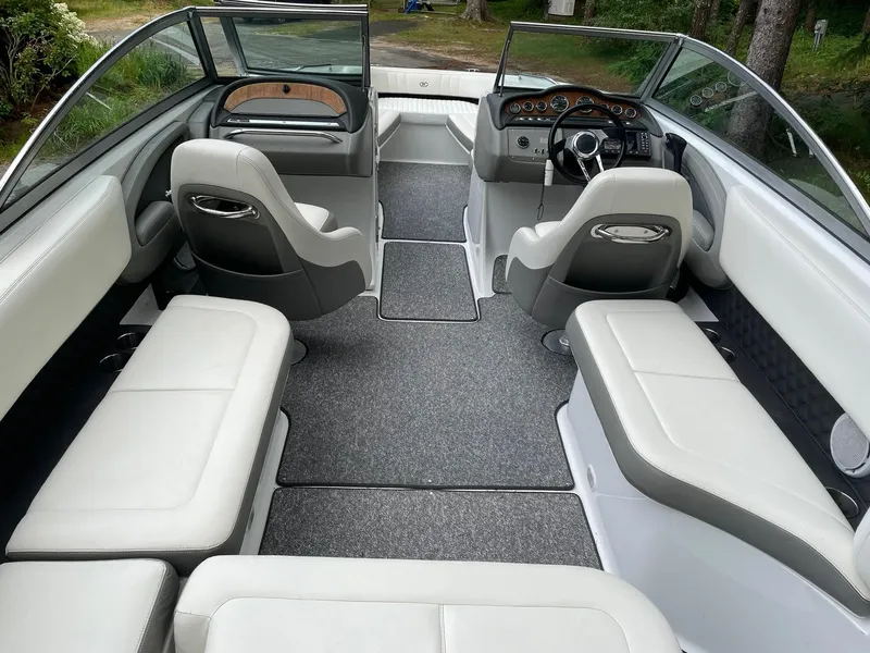 Slide: The Image of Interior of a 2010 Cobalt 262 boat with white seating and modern dashboard. - 7