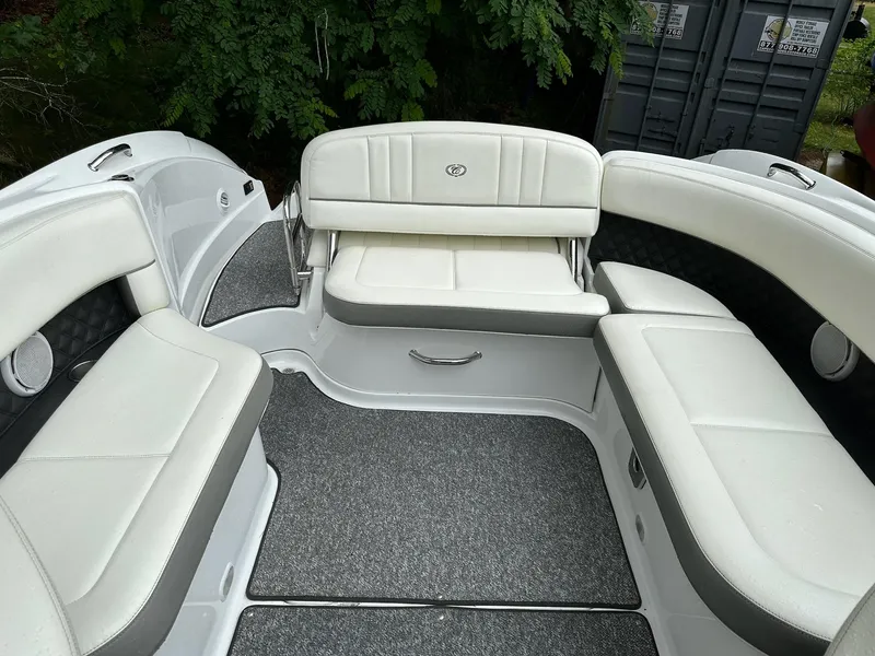 Slide: The Image of Interior of a 2010 Cobalt 262 boat with white cushioned seating. - 8
