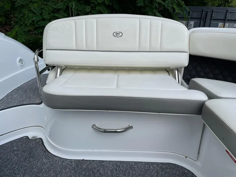 Slide: The Image of White leather seating on a 2010 Cobalt 262 boat, surrounded by greenery. - 9