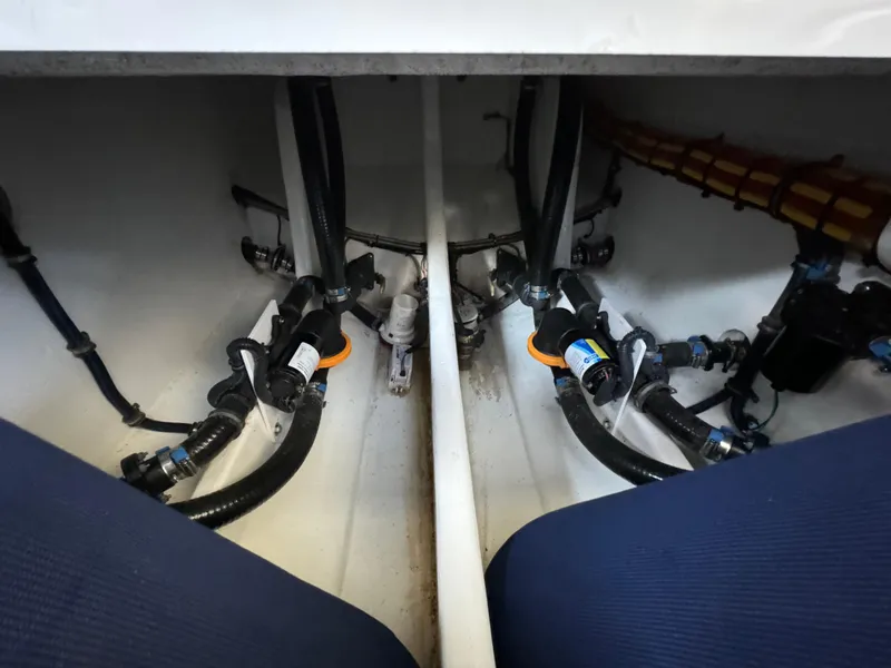Slide: The Image of 2019 Nor-Tech 390 Sport Center Console bilge area with hoses and fittings. - 12
