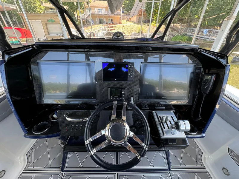 Slide: The Image of 2019 Nor-Tech 390 Sport Center Console dashboard with advanced navigation and control systems. - 14