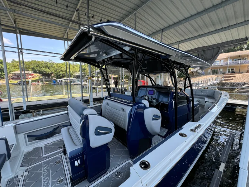 Slide: The Image of 2019 Nor-Tech 390 Sport Center Console boat docked under a covered marina. - 17