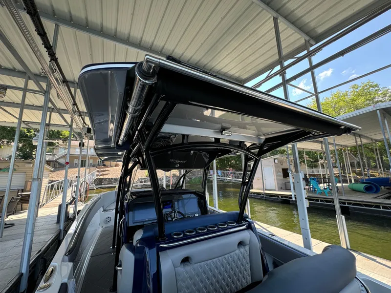 Slide: The Image of 2019 Nor-Tech 390 Sport Center Console boat docked under a covered marina. - 18